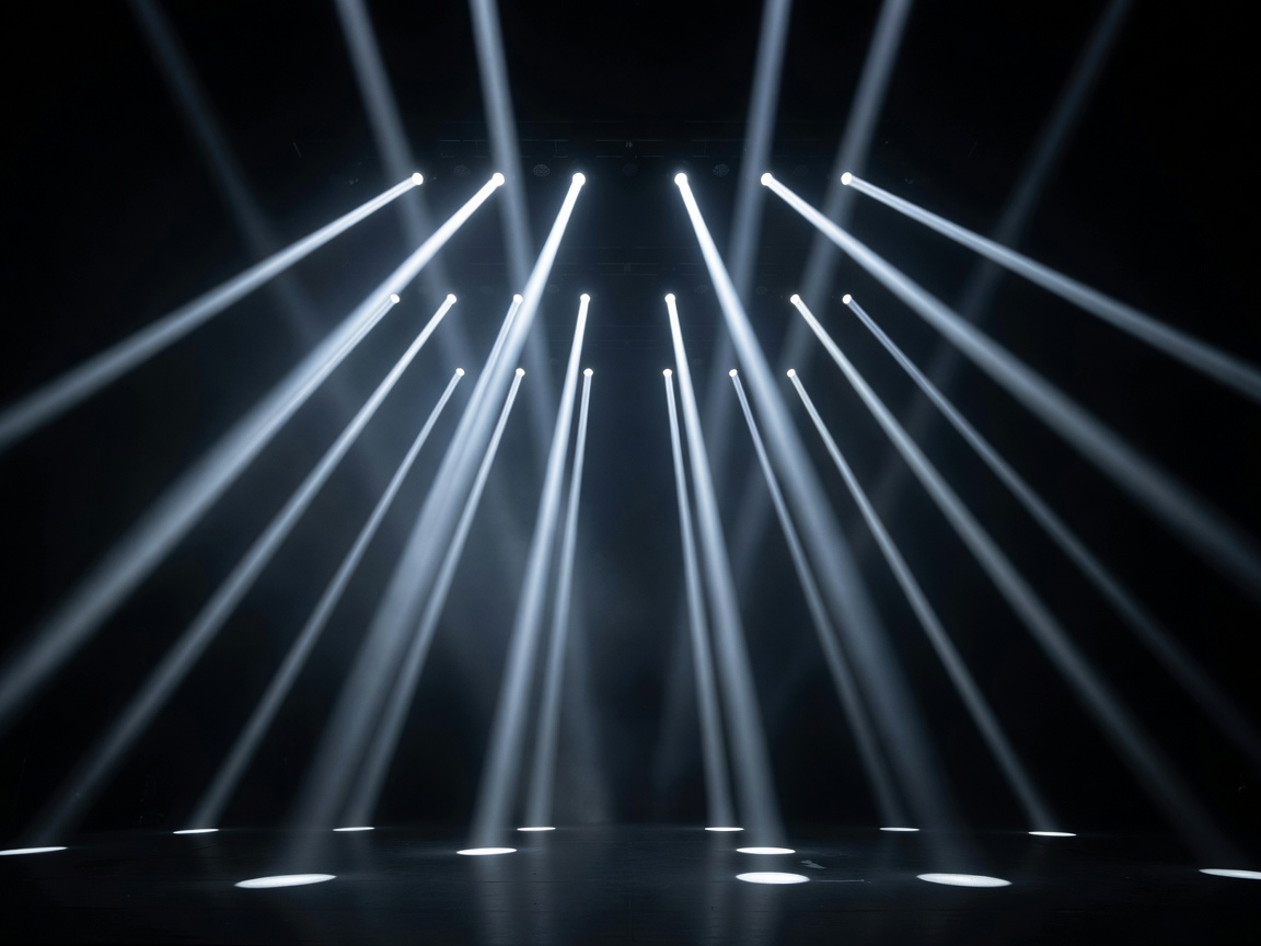 Parallel shafts of performance lighting extending above a dark stage